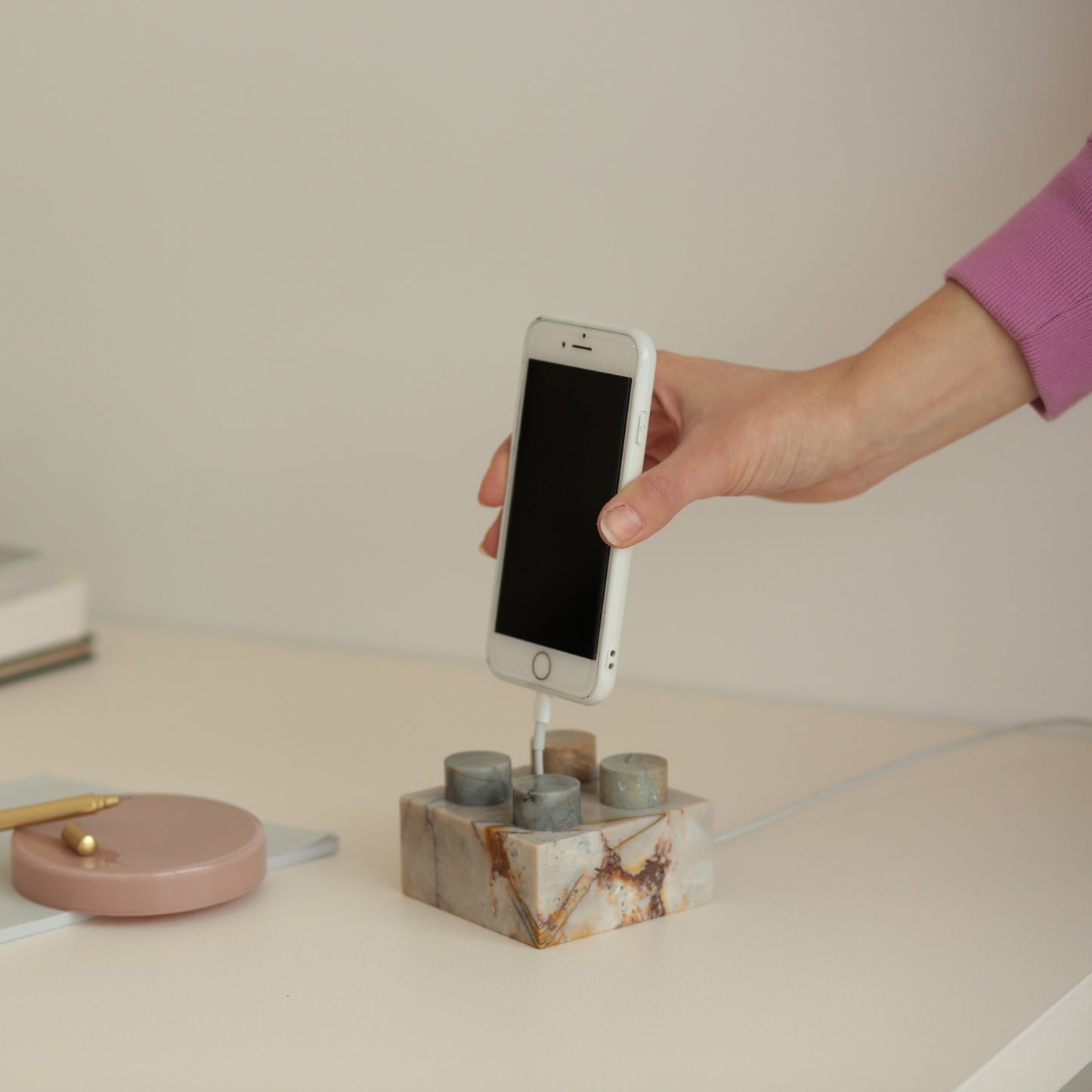 Creamy soapstone gemstone brick phone stand adding natural elegance to a contemporary workspace.