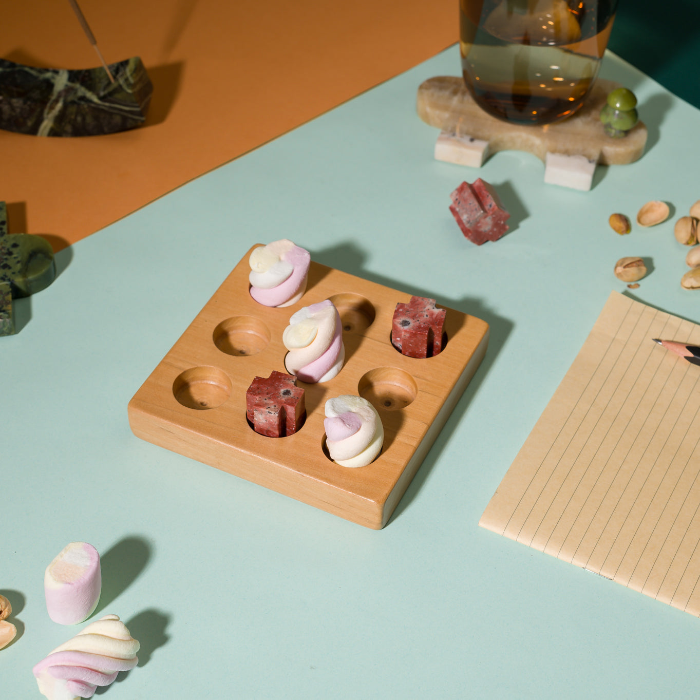 Decorative gemstone Tic Tac Toe puzzle integrated into a sophisticated coffee table arrangement.