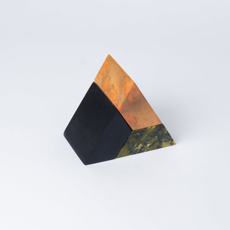 3-piece multi-color triangle puzzle in green, orange, and black stones on a white background.