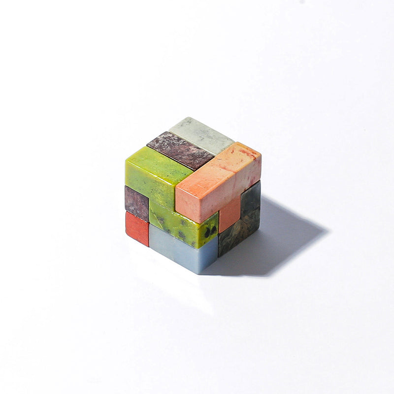 Standard-sized gemstone Soma cube puzzle displaying natural mineral textures on a white background.