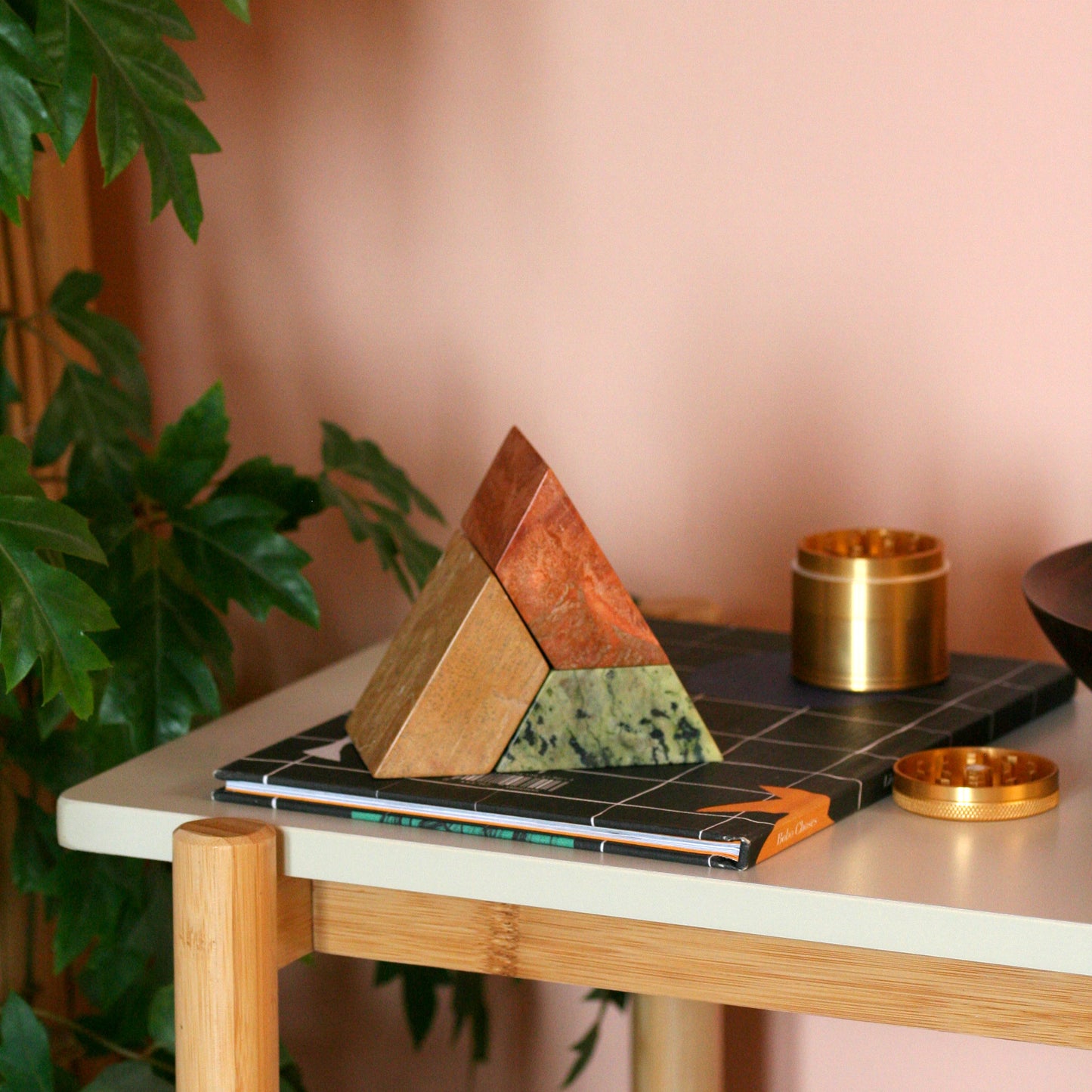 Multi-stone triangle puzzle sculpture adding an element of artistic slow design to an elegant setting.