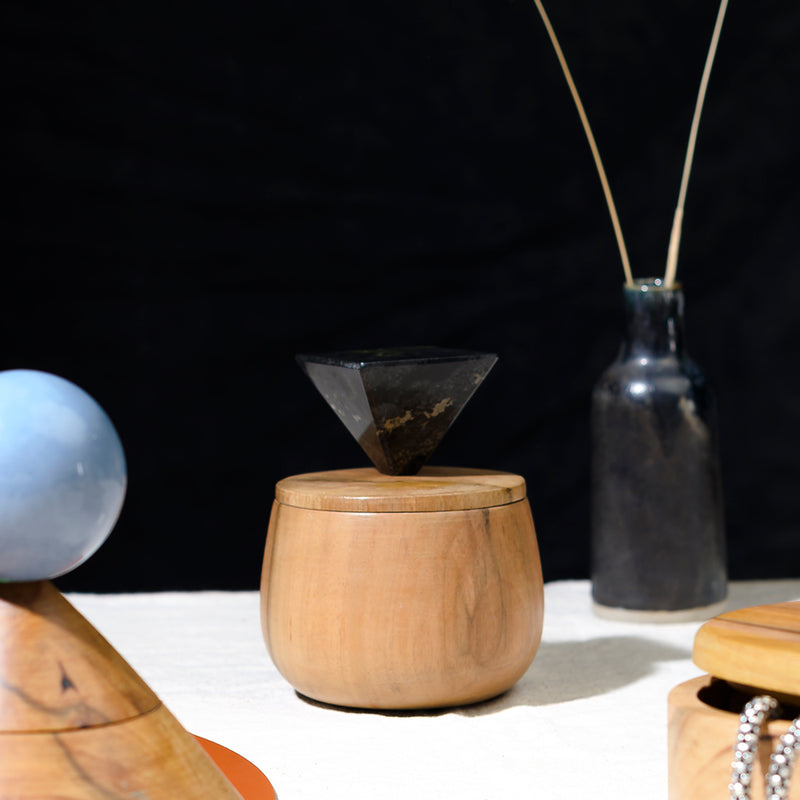 Black onyx gemstone round jewel box adding a touch of quiet luxury to a sophisticated dressing table.