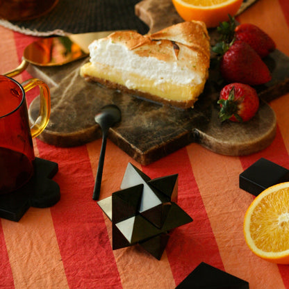 Black onyx decorative puzzle bringing depth and a sense of Andean materiality to an interior layout.