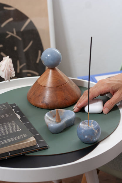Curated living room table display featuring the blue angelite catch-all and cone containers emphasizing Andean materiality.