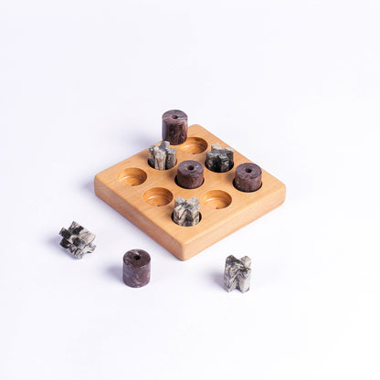 Solid gemstone Tic Tac Toe board highlighting its heavy Andean materiality and carved details on a white background.