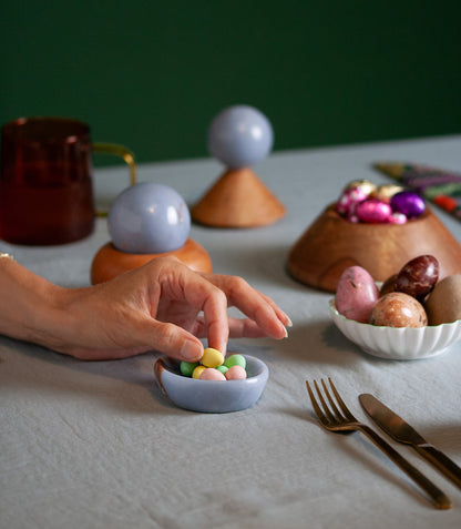 Assortment of handcrafted stone catch-all containers providing a sophisticated touch to a seasonal decor arrangement.