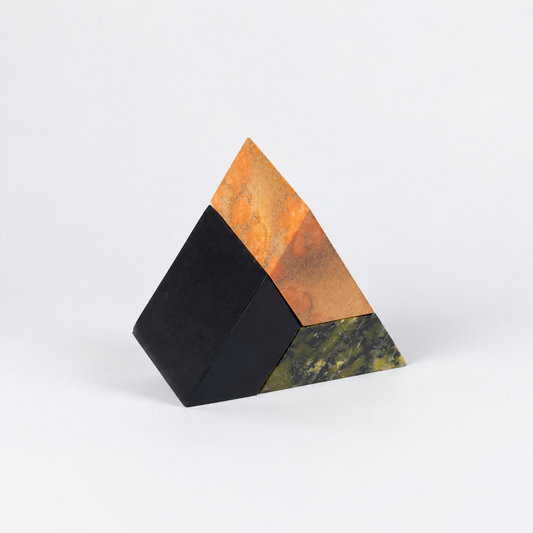 3-piece multi-color triangle puzzle in green, orange, and black stones on a white background.
