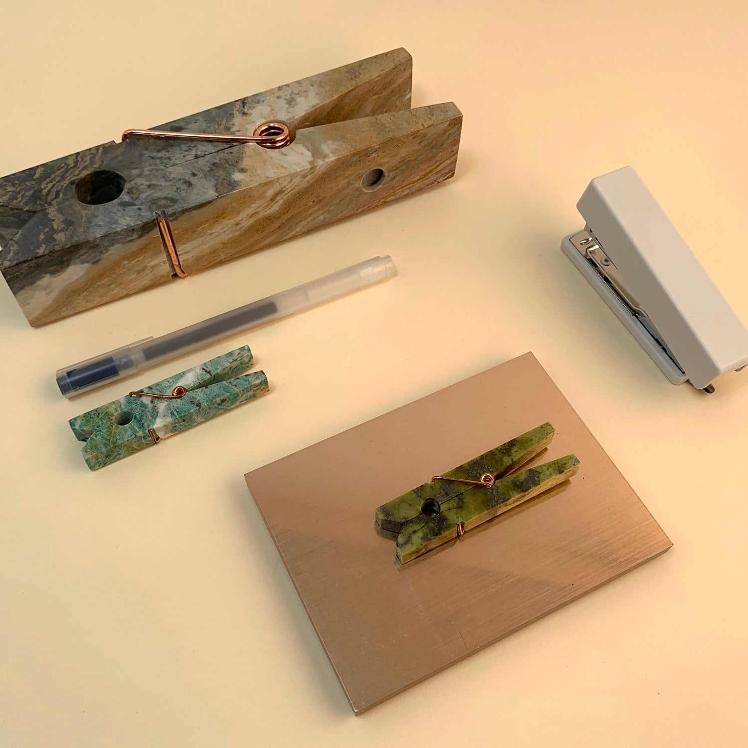 Serpentine green stone clip bringing organic elegance and heavy materiality to a functional decor setting.