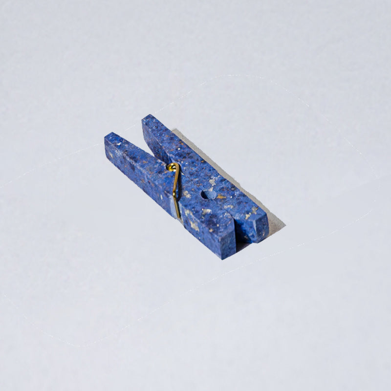 Solid Dumortierite blue gemstone laundry clip displaying natural mineral textures on a white background.