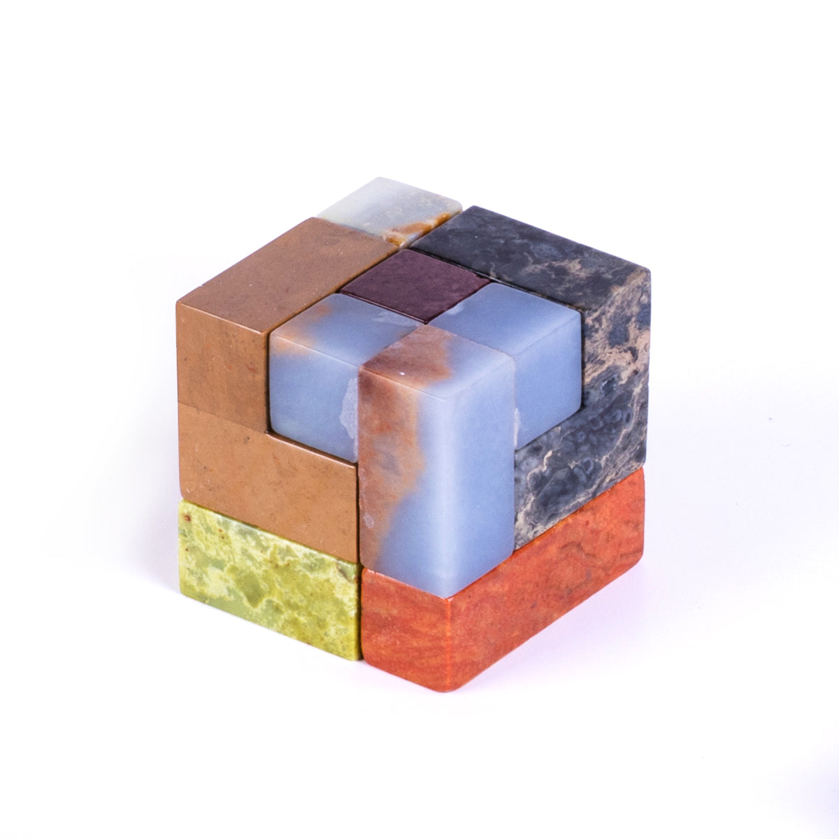 Fully assembled gemstone cube puzzle showcasing the precision of its 3D interlocking stone blocks on a pristine white background.