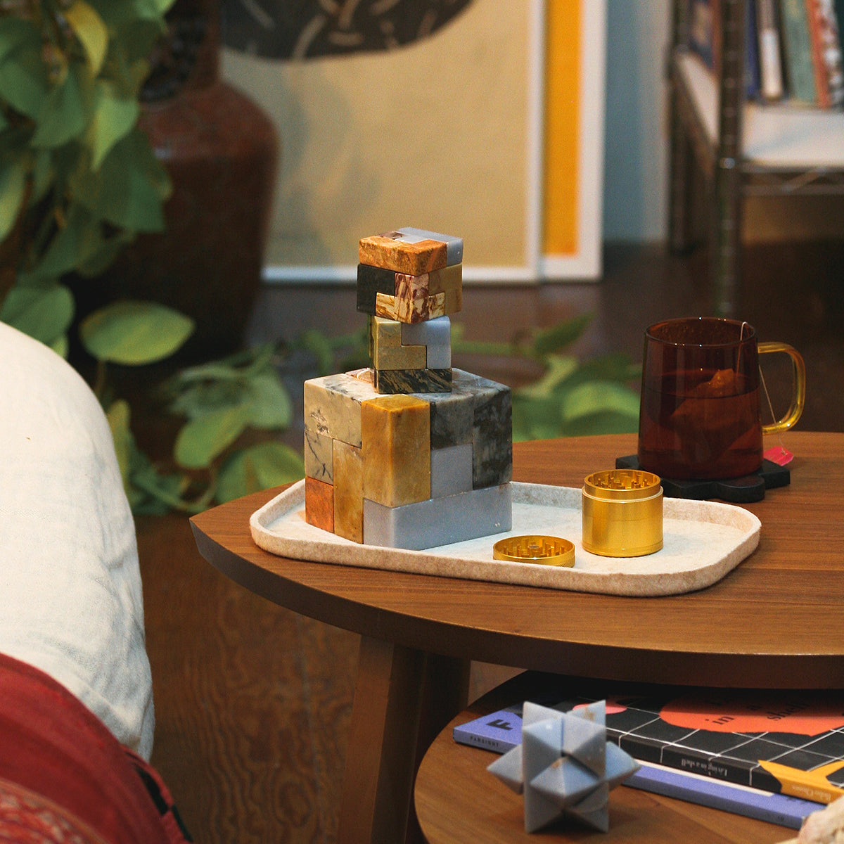All individual geometric blocks of the gemstone Soma cube scattered elegantly, showcasing the distinct handcrafted shape of every single Andean stone piece.