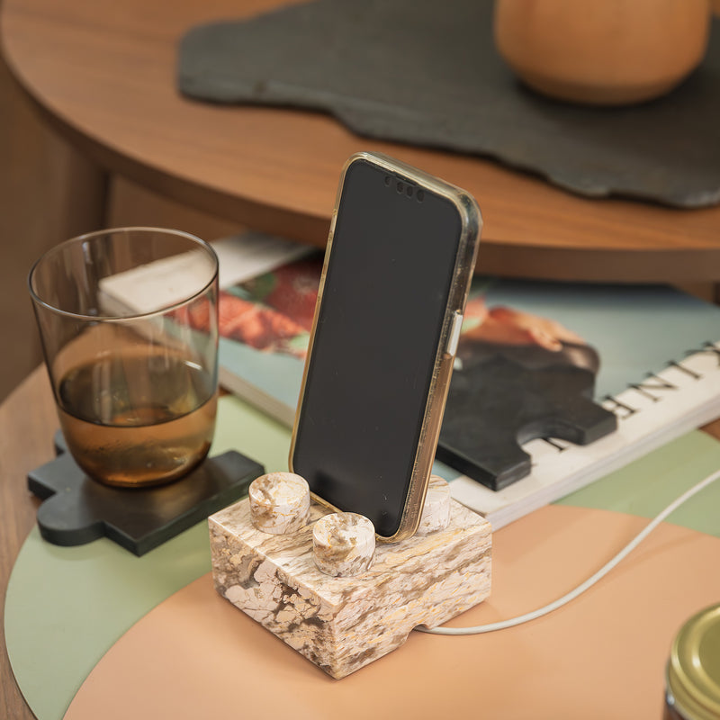 Handcrafted creamy soapstone brick phone stand integrated into a minimalist desk setting.