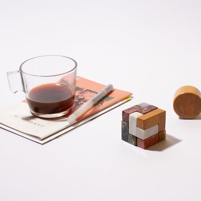 Low-angle perspective of the handcrafted stone cube, emphasizing its architectural shape and sculptural presence.