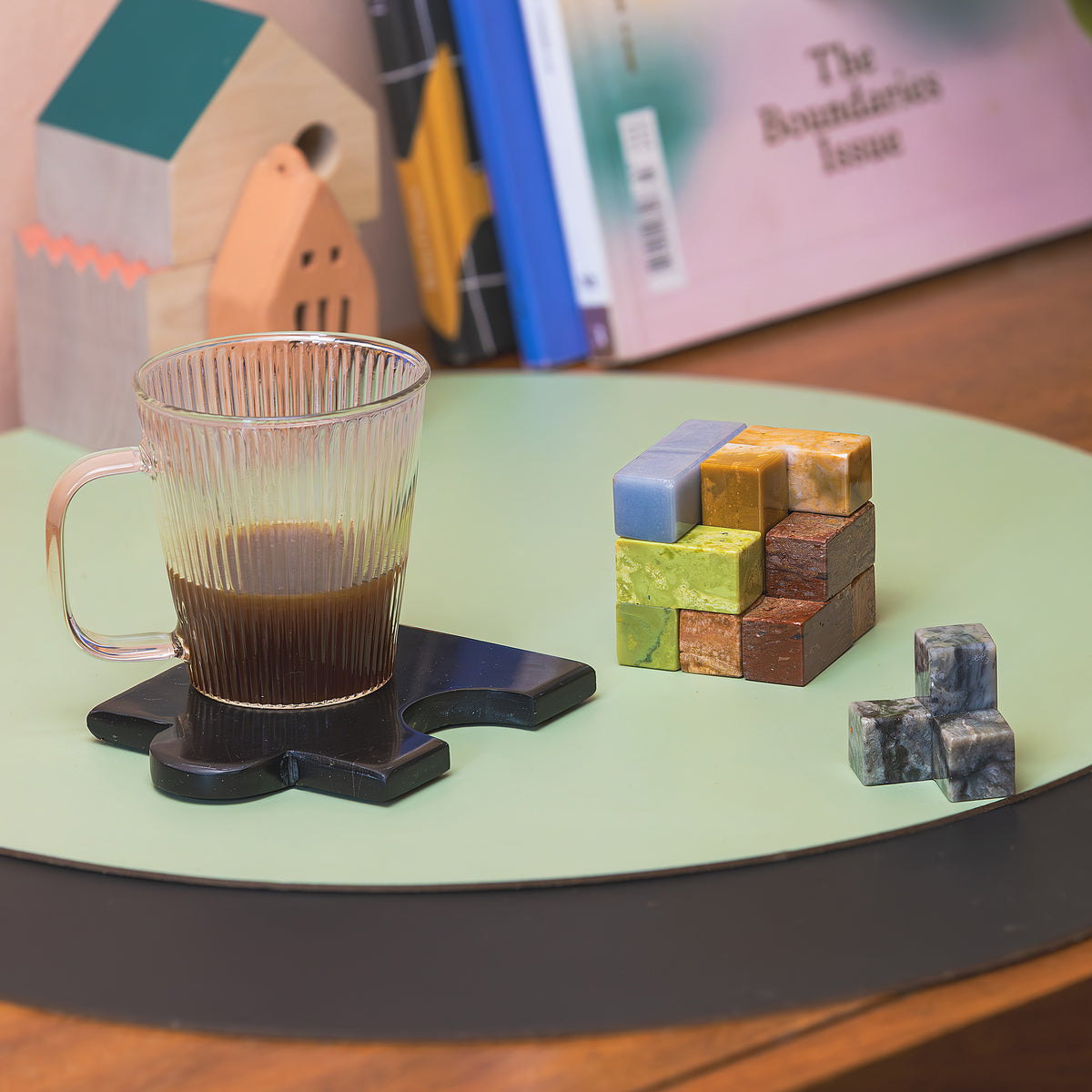The heavy mineral cube puzzle displayed elegantly on a contemporary shelf, blending functional gameplay with high-end interior aesthetics.