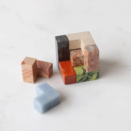 Top-down view of the assembled gemstone puzzle, revealing the subtle natural color variations and organic textures inherent to Andean materiality.