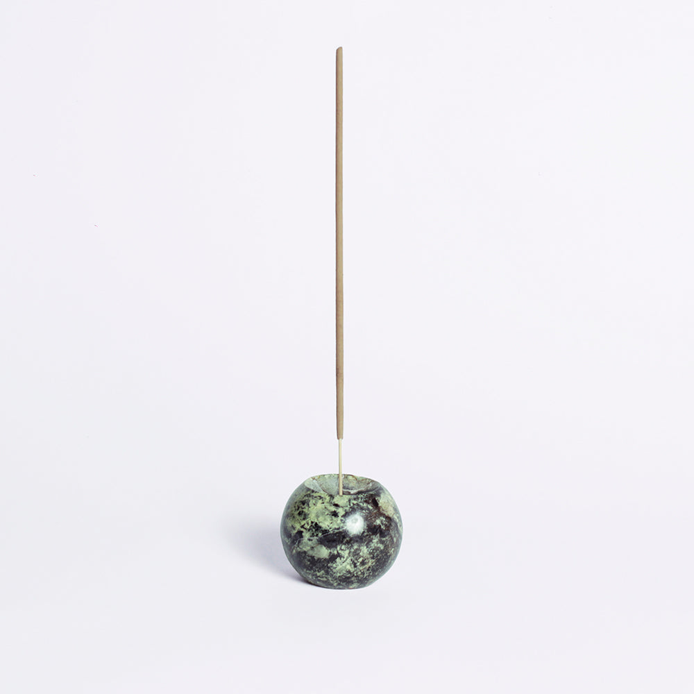 Serpentine green gemstone sphere incense holder showcasing its natural Andean stone texture on a white background.