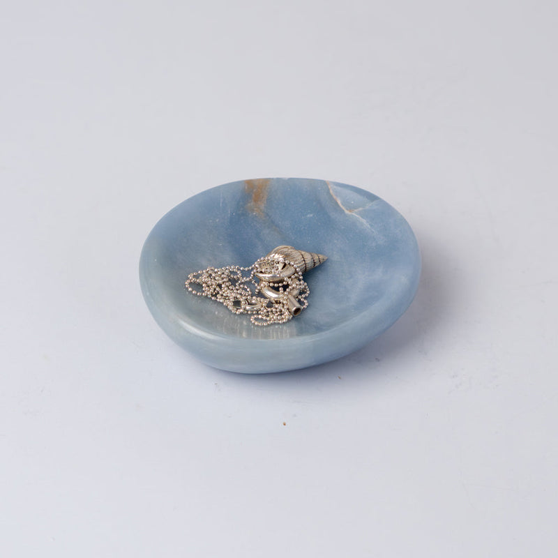 Organic 4-inch blue angelite gemstone catch-all dish displaying soft natural hues on a white background.