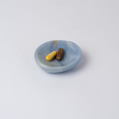 Solid blue angelite stone catch-all highlighting its handcrafted organic shape on a white background.