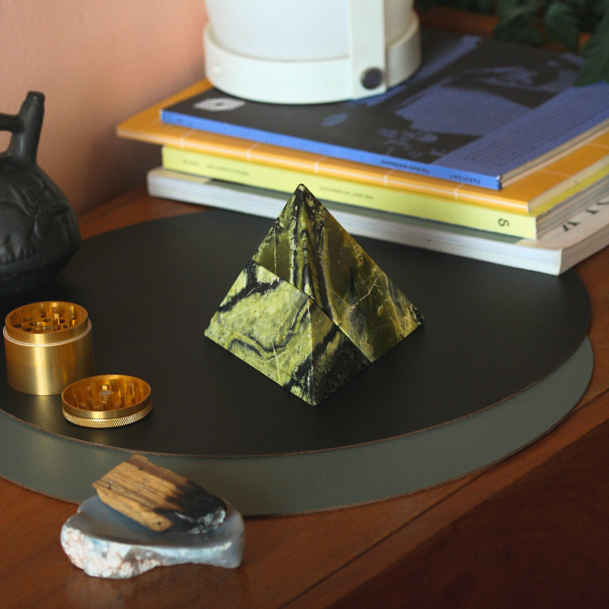 Serpentine stone pyramid puzzle enhancing a minimalist environment with its organic elegance.