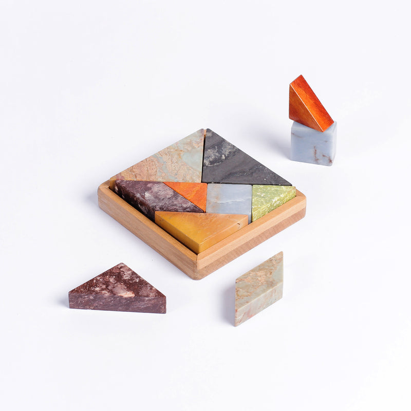 Multi-stone Tangram gemstone puzzle displaying intricate natural tones on a white background.