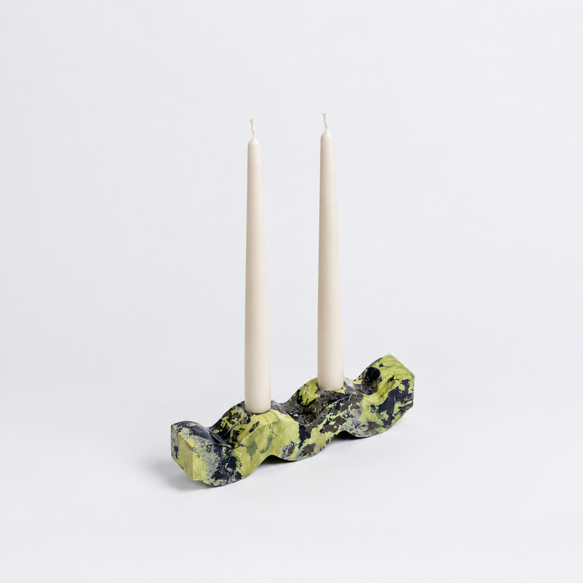 Wavy serpentine green gemstone candelabra displaying its rich natural tones on a white background.