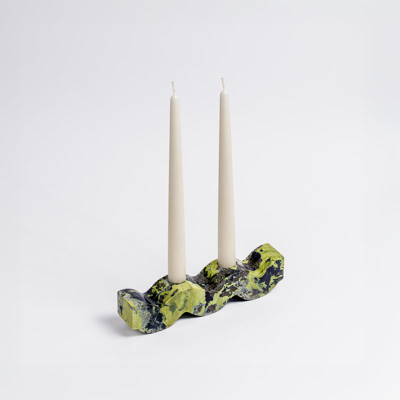 Wavy serpentine green gemstone candelabra displaying its rich natural tones on a white background.