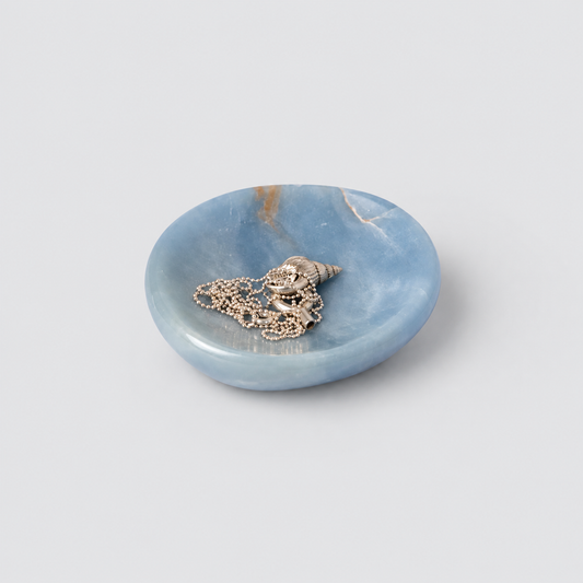 Organic 4-inch blue angelite gemstone catch-all dish displaying soft natural hues on a white background.