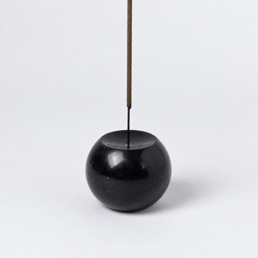 Close-up view of the black onyx gemstone sphere incense holder highlighting its smooth, dark finish on a white background.
