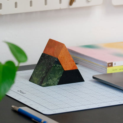 Triangle sculptural puzzle carved from gemstones and semi-precious stone for the desktop